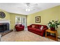 Comfortable living room featuring a cozy fireplace, plush seating, and natural light at 812 Manning Sw Way, Marietta, GA 30064