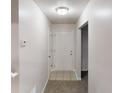 Hallway with neutral walls, carpeted floors, a white door, and access to other rooms at 765 Stonebridge Run, Lithonia, GA 30058