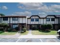 Townhome exterior featuring a well-kept lawn and charming architectural details at 1199 Ashborough Se Dr # K, Marietta, GA 30067