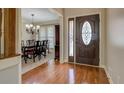 Inviting foyer with hardwood flooring, an elegant front door, and a view of the dining room at 1391 Sutters Dr, Lawrenceville, GA 30045