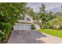 Charming two-story home featuring a two-car garage, manicured lawn, and mature trees at 441 Amy Blvd, Temple, GA 30179