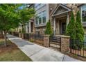 Beautiful townhome community on tree-lined street with landscaped front yards and sidewalks for pedestrian-friendly neighborhood at 1120 Cordia Nw Ave, Atlanta, GA 30318