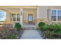 Welcoming front porch with stone accents, elegant columns, and attractive landscaping enhance this home at 3173 Rockbridge Rd, Avondale Estates, GA 30002