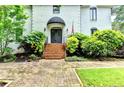 Stately entrance with brick steps leading to a double door, complemented by manicured landscaping at 5025 Oak Bluff Ct, Atlanta, GA 30350