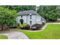 Well-maintained two-story home with lush greenery and a beautifully paved driveway at 5025 Oak Bluff Ct, Atlanta, GA 30350