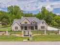 Charming brick home featuring well-kept front lawn, elegant fence, and a welcoming entrance gate at 140 Maranatha Trl, Lawrenceville, GA 30045