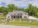 Gorgeous brick home with expansive front yard, decorative fence, and a well-manicured lawn at 140 Maranatha Trl, Lawrenceville, GA 30045