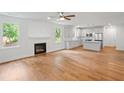 Stylish open-concept space with fireplace, hardwood floors, and white kitchen with stainless steel appliances at 2714 Eagles Crest Ln, Decatur, GA 30034
