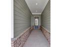 Inviting entryway with gray wood-look siding and a charming front door with glass panels at 107 Cedar Brook Dr, Canton, GA 30115