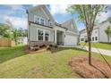 Charming two-story home with a well-manicured lawn, inviting front entrance and an attached garage at 107 Cedar Brook Dr, Canton, GA 30115