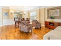 Elegant dining room featuring hardwood floors, chandelier, and plenty of natural light at 2810 Promenade Pl, Buford, GA 30519