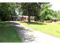 Brick home with a long driveway and spacious front yard, surrounded by trees at 579 Kenridge Cir, Stone Mountain, GA 30083