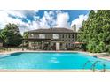 Backyard oasis featuring a large swimming pool, covered patio, outdoor seating, and landscaped surroundings at 208 Eagles Flight, Villa Rica, GA 30180