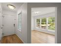 Bright foyer with hardwood floors, white walls, and decorative glass in a front window at 403 Abingdon Way, Atlanta, GA 30328