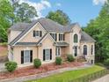 Charming home with a landscaped front yard, featuring a mix of stone and stucco at 503 Kensington Estates Trce, Woodstock, GA 30188