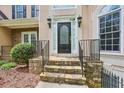 Elegant front door entrance with stone steps and decorative iron railings at 503 Kensington Estates Trce, Woodstock, GA 30188
