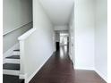Entryway with dark wood floors and white walls, leading into the home at 5620 Moresby Ct, Alpharetta, GA 30022