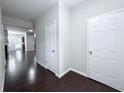 Hallway features dark wood flooring, with white doors and light gray walls at 5620 Moresby Ct, Alpharetta, GA 30022