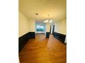 Bright dining room with hardwood floors, wainscoting, and a stylish chandelier at 225 Colser Dr, Covington, GA 30016