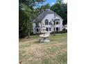 Charming two-story home with a lush green lawn and a beautiful tiered fountain at 2655 Boulder Creek Ne Dr, Roswell, GA 30075