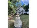 Charming two-story home with a lush green lawn and a beautiful tiered fountain at 2655 Boulder Creek Ne Dr, Roswell, GA 30075