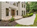 A close up of a front entrance with a stone walkway and a concrete path leading up to the door at 2655 Boulder Creek Ne Dr, Roswell, GA 30075