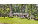 Traditional-style home with lush lawn and mature trees offers a serene, park-like setting at 3792 Harts Mill Ne Ln, Brookhaven, GA 30319