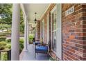Inviting covered front porch, complete with seating, provides a relaxing outdoor space at 3792 Harts Mill Ne Ln, Brookhaven, GA 30319