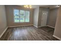 Inviting dining room with large windows and new gray vinyl floors at 4052 Keheley Glen Ne Dr, Marietta, GA 30066