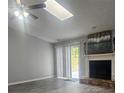 Bright living room with fireplace, skylight and sliding glass doors to patio at 4052 Keheley Glen Ne Dr, Marietta, GA 30066
