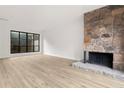 Spacious living room with stone fireplace and large picture window overlooking a landscaped yard at 683 Highland Ct, Marietta, GA 30068