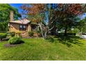 Quaint brick home featuring a well-manicured lawn and beautiful, mature shade trees at 1029 Katherwood Sw Dr, Atlanta, GA 30310