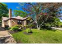 Quaint brick home with landscaped front yard, chimney, and mature shade tree at 1029 Katherwood Sw Dr, Atlanta, GA 30310