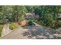 Beautiful home surrounded by mature trees and lush landscaping on a cul-de-sac at 2080 Old Dominion Rd, Atlanta, GA 30350