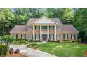 A traditional brick home with white columns, shutters, and a manicured front lawn at 2080 Old Dominion Rd, Atlanta, GA 30350