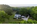 Aerial view of a beautiful home surrounded by lush greenery showcasing its private location and spacious grounds at 253 Pine Valley Dr, Powder Springs, GA 30127