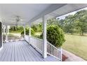 Spacious covered front porch featuring painted wood floors and ample room for seating with picturesque views at 253 Pine Valley Dr, Powder Springs, GA 30127