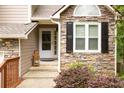 Welcoming entryway featuring a stone facade, a bright window, and a well-maintained front door at 3573 Bramwell Nw Xing, Kennesaw, GA 30144