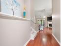 Bright hallway with hardwood floors leading into the living room with a fireplace and sliding glass doors at 3573 Bramwell Nw Xing, Kennesaw, GA 30144
