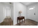 Bright foyer featuring wood floors, a white front door, and a decorative table at 3904 Bakers Ferry Sw Rd, Atlanta, GA 30331