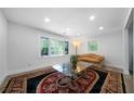 Inviting living room with large windows, an area rug, and recessed lighting at 3904 Bakers Ferry Sw Rd, Atlanta, GA 30331