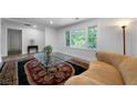 Bright living room boasts a large window, an area rug, and recessed lighting at 3904 Bakers Ferry Sw Rd, Atlanta, GA 30331
