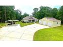 Charming exterior featuring a well-manicured lawn, covered parking, and a detached two-car garage at 7460 Highway 101 N, Rockmart, GA 30153