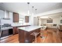 Modern kitchen featuring stainless steel appliances, hardwood floors, and a stylish island with bar seating at 1202 Laurel Cliff Se Dr, Smyrna, GA 30082