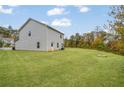 Spacious back yard featuring a well-maintained lawn and the home's exterior at 3530 Ridge Hill Pkwy, Douglasville, GA 30135
