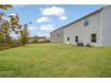 Grassy back yard extending from the home to the tree line and neighboring house at 3530 Ridge Hill Pkwy, Douglasville, GA 30135