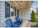 Relaxing front porch featuring two blue Adirondack chairs, offering a cozy outdoor space at 3530 Ridge Hill Pkwy, Douglasville, GA 30135
