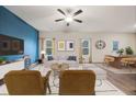 Stylish living room with a blue accent wall, modern furniture, and plenty of natural light at 3530 Ridge Hill Pkwy, Douglasville, GA 30135