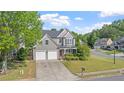 Attractive home with a well-maintained lawn, mature trees, and a double driveway leading to a two-car garage at 3525 Elder Field Ln, Cumming, GA 30040