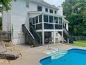 A stunning backyard features a pool, a screened in porch, and multiple staircases at 402 Hancock Ct, Woodstock, GA 30188